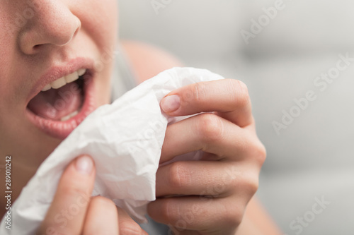 sneezes and coughs up in tissue