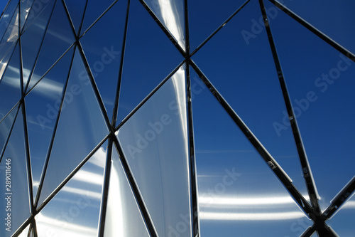 Abstract background of polished metal panels of a triangular shape.