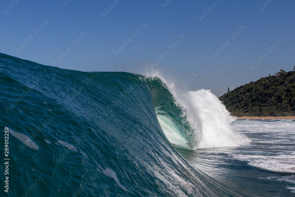 huge wave crashing on the beach, close up action photo while swimming huge wave crashing on the beach, close up action photo while swimming