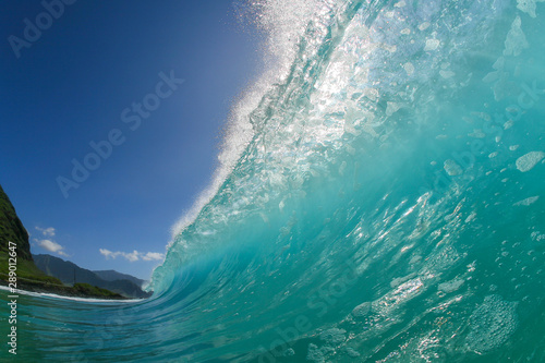 huge blue wave crashing on a beach