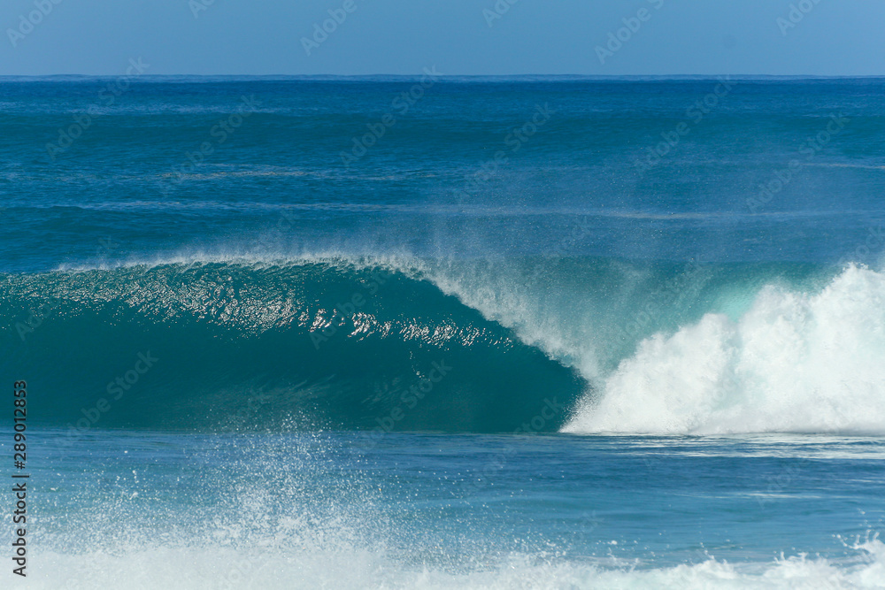 huge wave breaking at pipeline beach in hawaii