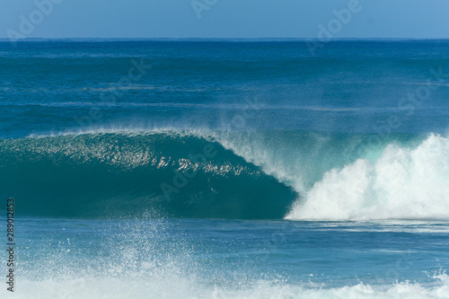 huge wave breaking at pipeline beach in hawaii