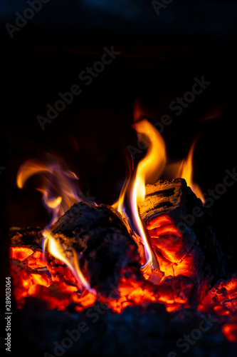 Fire is red in a closed oven on black background. 2019