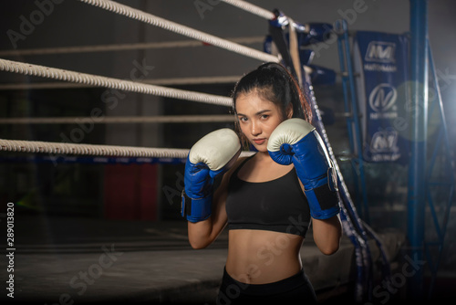 Muay Thai woman and Healthy concept.Boxing Women prepare to trianing session and kickboxing,workout at thai boxing gym.Fit Female exercise hard to strengther muscle.
