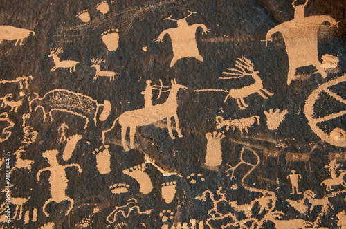 Hunting petroglyph on patinated cliff face, Newspaper Rock State Historical Park, Utah	  photo