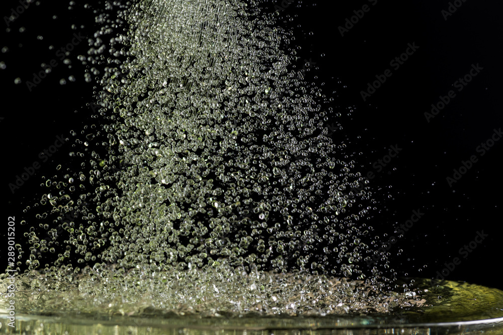 a lot of falling drops on a black background, like heavy rain a lot of falling drops on a black background, like heavy rain