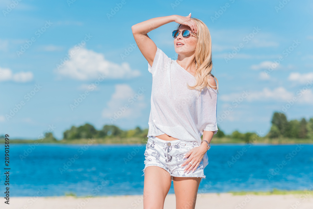 Adventure concept, blonde hair woman at the beach, vacation and holidays time Adventure concept, blonde hair woman at the beach, vacation and holidays time