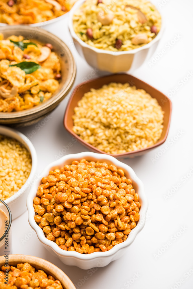 Group of Cornflake and Thick Poha Chivda or Chiwda and Chatpata Masala chana and fried crispy Moong Dal, served in a bowl. selective focus Group of Cornflake and Thick Poha Chivda or Chiwda and Chatpata Masala chana and fried crispy Moong Dal, served in a bowl. selective focus