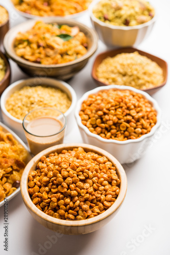 Group of Cornflake and Thick Poha Chivda or Chiwda and Chatpata Masala chana and fried crispy Moong Dal, served in a bowl. selective focus