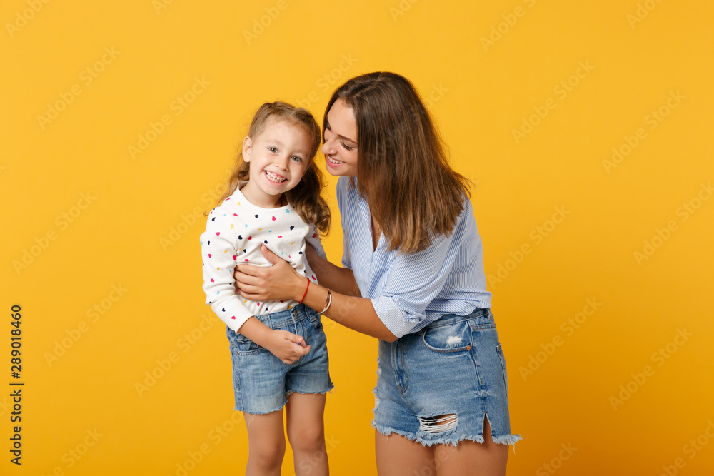 Woman in light clothes have fun with cute child baby girl 4-5 years old. Mommy little kid daughter isolated on yellow background studio portrait. Mother's Day love family parenthood childhood concept. Woman in light clothes have fun with cute child baby girl 4-5 years old. Mommy little kid daughter isolated on yellow background studio portrait. Mother's Day love family parenthood childhood concept.