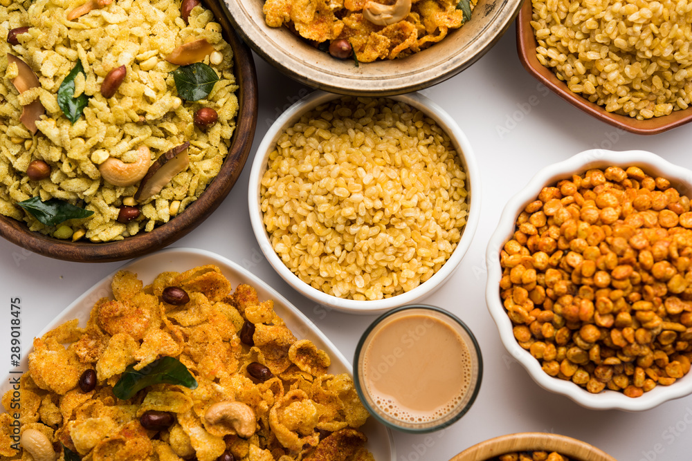 Group of Cornflake and Thick Poha Chivda or Chiwda and Chatpata Masala chana and fried crispy Moong Dal, served in a bowl. selective focus Group of Cornflake and Thick Poha Chivda or Chiwda and Chatpata Masala chana and fried crispy Moong Dal, served in a bowl. selective focus
