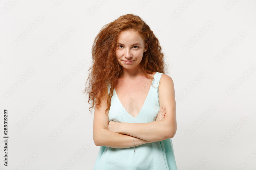 Young smiling redhead woman girl in casual light clothes posing isolated on white wall background studio portrait. People sincere emotions lifestyle concept. Mock up copy space. Holding hands crossed. Young smiling redhead woman girl in casual light clothes posing isolated on white wall background studio portrait. People sincere emotions lifestyle concept. Mock up copy space. Holding hands crossed.