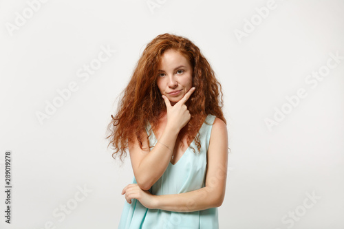 Young pensive redhead woman girl in casual light clothes posing isolated on white background, studio portrait. People sincere emotions lifestyle concept. Mock up copy space. Put hand prop up on chin.