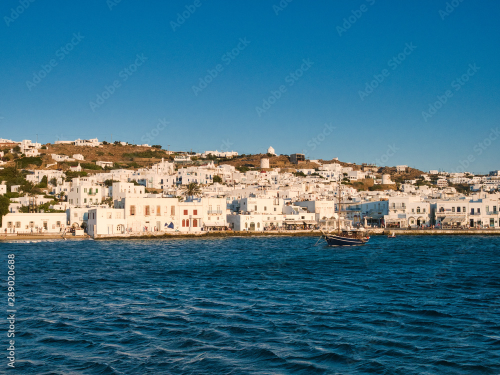 Picturesque seascape with boats and white buildings