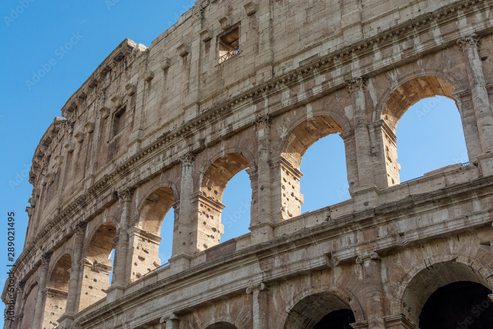 Side view of Colosseum in Rome, Italy, Famous Italian sightseeing on the clear blue sky