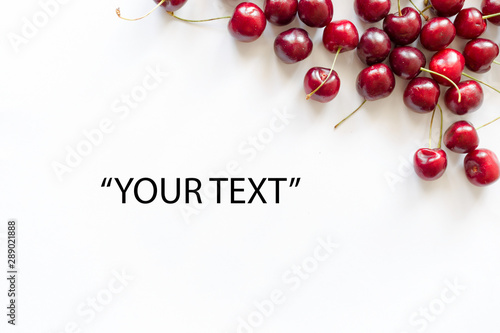 Frame of red cherries on a white background. View from above. For design themes of fresh berries and fruits, food, health. Image with copy space for text.