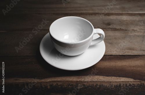 An empty coffee cup on an old wooden table