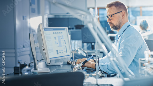 Electronics Development Engineer Working on Computer  Designing Motherboard  Doing Maintenance of Devices and Soldering Circuit Boards. Professional working in Bright and Modern Office 