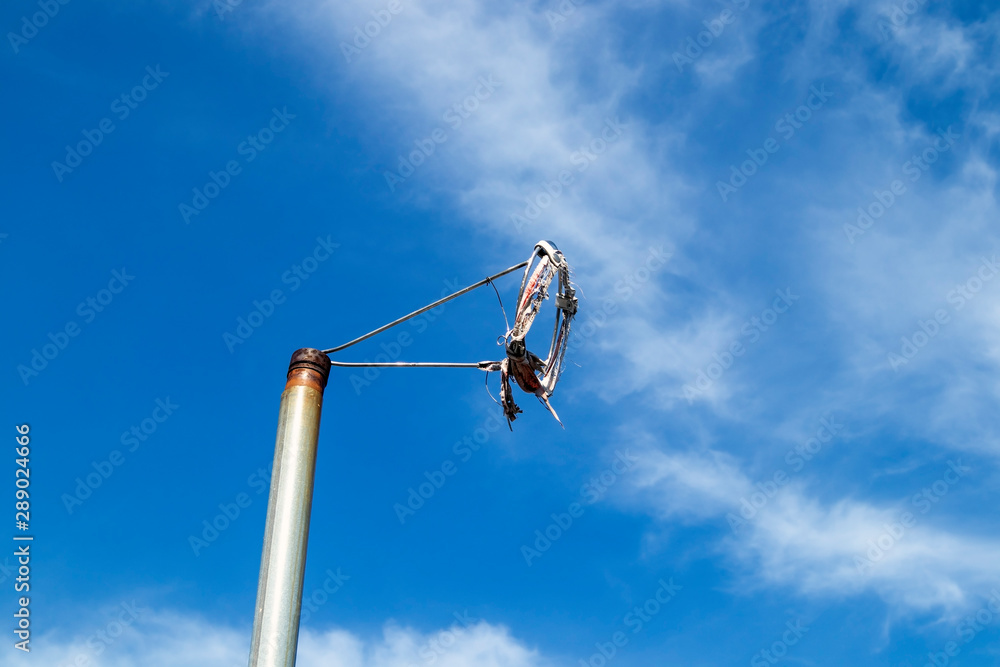 worn out windsock frame against blue sky worn out windsock frame against blue sky