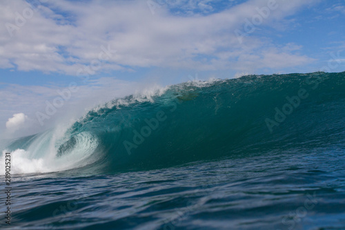 huge blue wave breaking in the ocean © Ryan