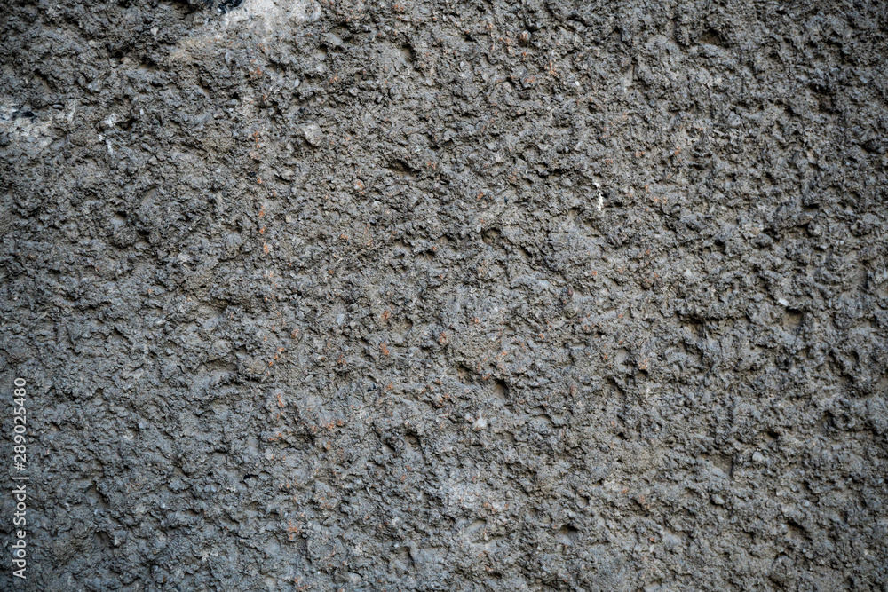 Texture of an old cracked concrete wall. Background image of a worn gray concrete surface Texture of an old cracked concrete wall. Background image of a worn gray concrete surface