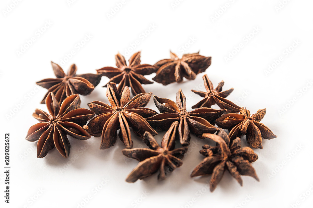 Seasonings are isolated on a white background. Star anise on a white background close-up and copy space. Seasonings are isolated on a white background. Star anise on a white background close-up and copy space.