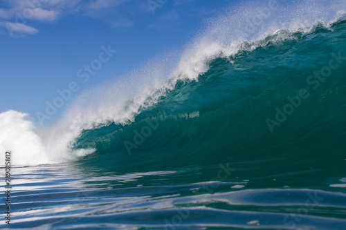 huge powerful wave crashing on a shallow reef
