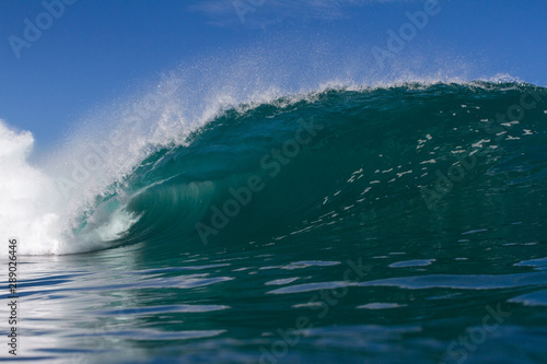 huge wave crashing on a shallow reef in hawaii