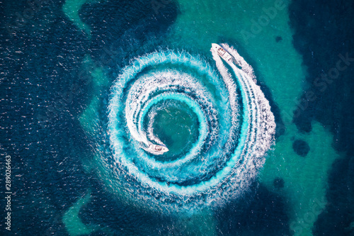 Fotografie, Obraz Zwei Motorboote formen einen Kreis aus Luftblasen und Wellen auf dem türkisem Me