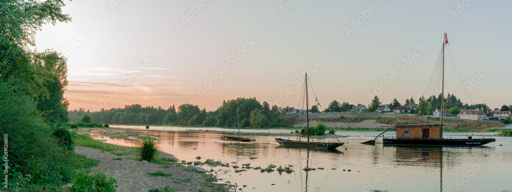 Εκτύπωση καμβά wooden riverboats ona calm Loire River at sunset in the French countryside near