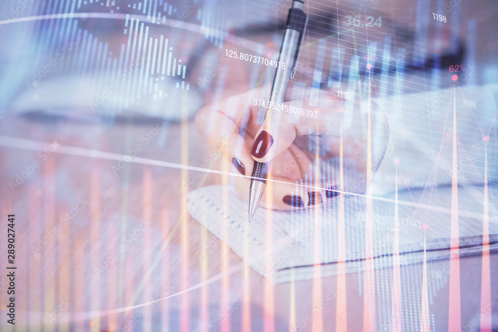 Multi exposure of hands making notes with forex chart huds. Stock market concept. Multi exposure of hands making notes with forex chart huds. Stock market concept.