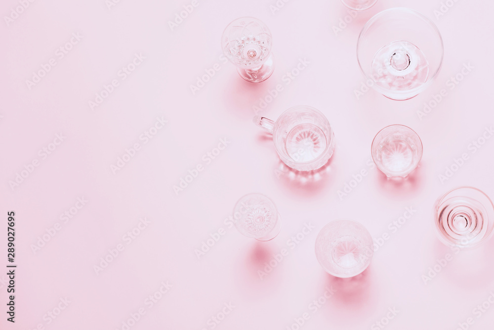 Many empty glasses on pink background. Top view, flat lay Many empty glasses on pink background. Top view, flat lay