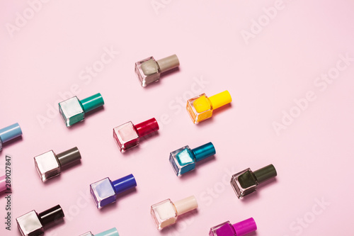 Colorful Nail polish bottles pattern background. Close up.