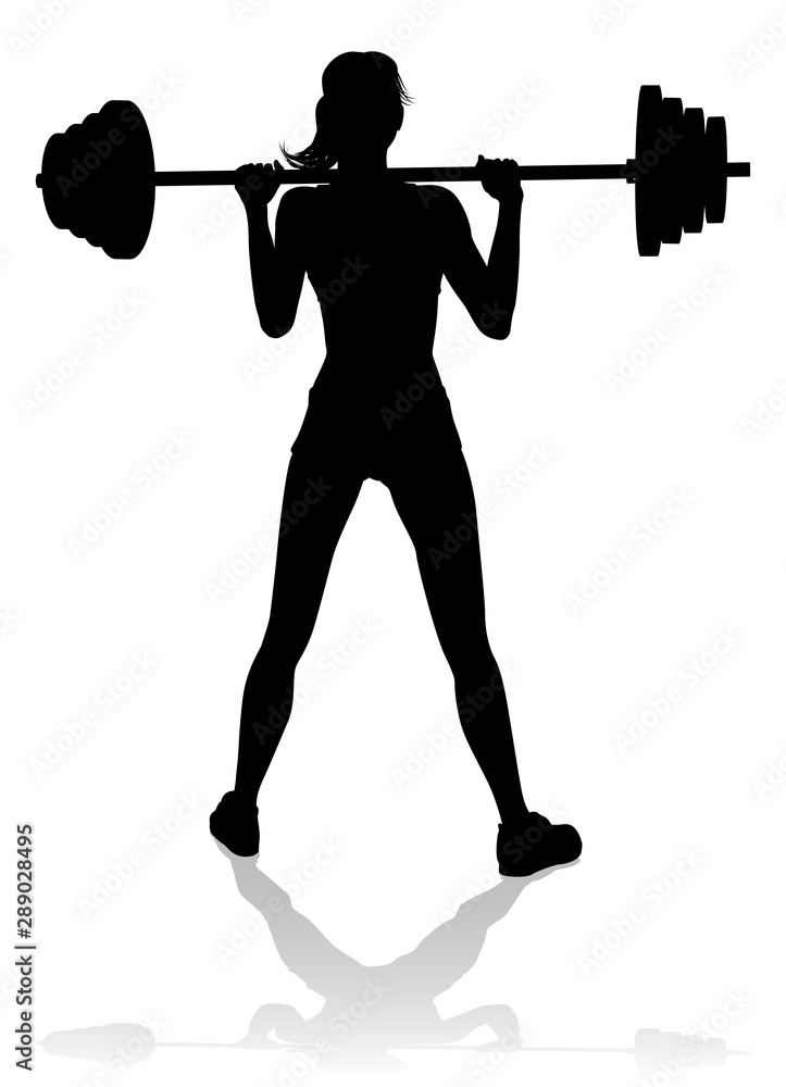 Φωτογραφία A woman in silhouette using barbell weights fitness exercise gym equipment
