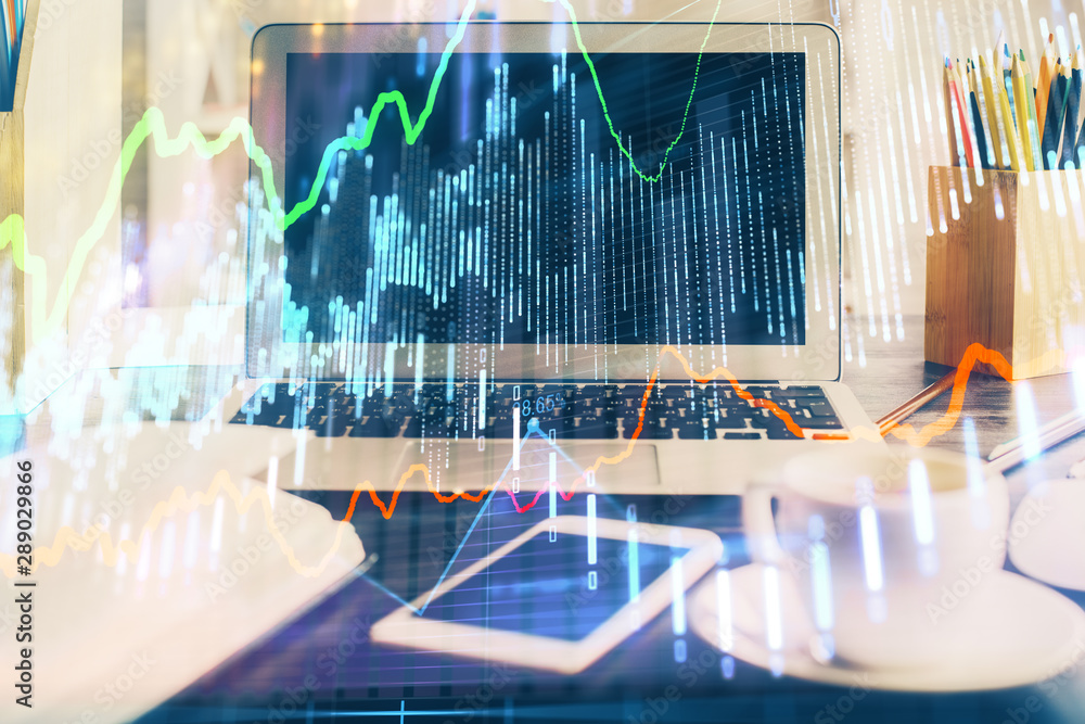 Forex market chart hologram and personal computer background. Multi exposure. Concept of investment. Forex market chart hologram and personal computer background. Multi exposure. Concept of investment.