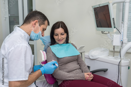 Woman in dentistry pointing at teeth sampler