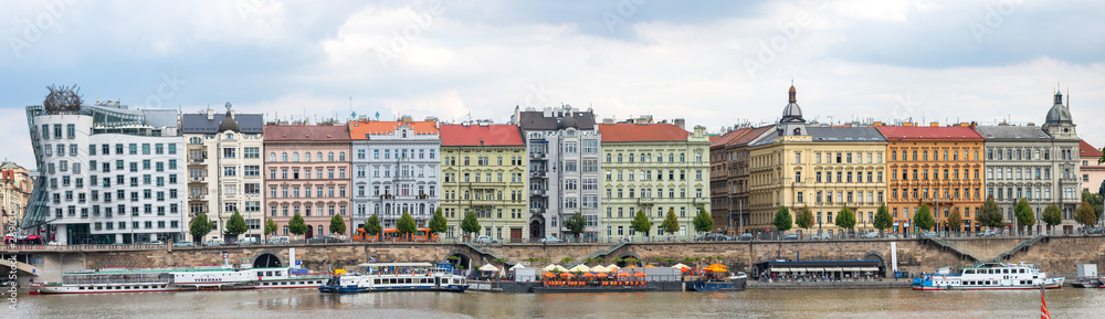 Fototapeta premium Prague palaces with the dancing house or Fred and Ginger on the Vltava river