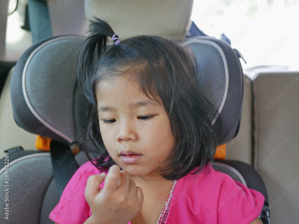 Little Asian baby girl looking at her own boogers after picking her nose - child habit / behavior Little Asian baby girl looking at her own boogers after picking her nose - child habit / behavior