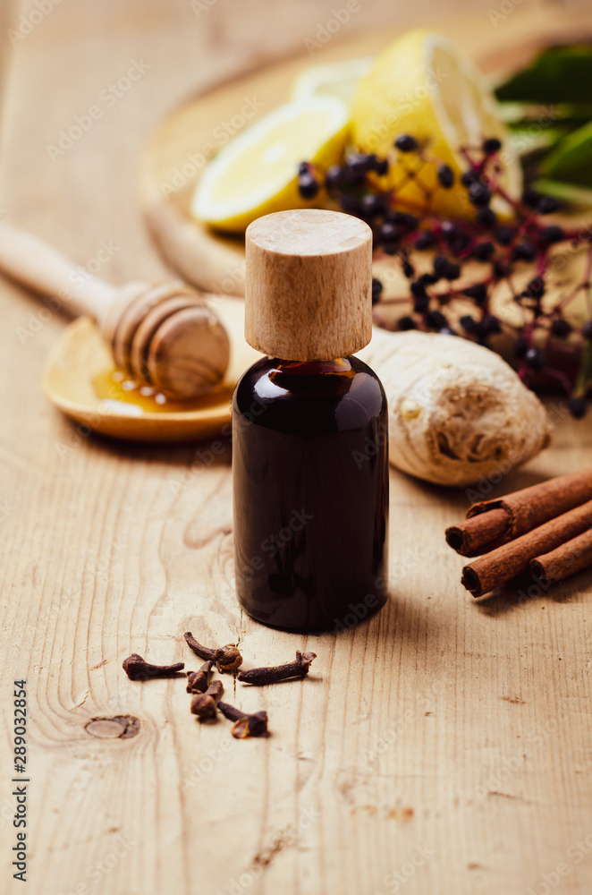 Elderberry syrup with honey, ginger, cinnamon,cloves. Homemade remedy for Immune boosting for flu season, colds. Elderberry syrup with honey, ginger, cinnamon,cloves. Homemade remedy for Immune boosting for flu season, colds.