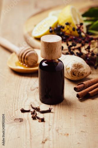 Elderberry syrup with honey, ginger, cinnamon,cloves. Homemade remedy for Immune boosting for flu season, colds.