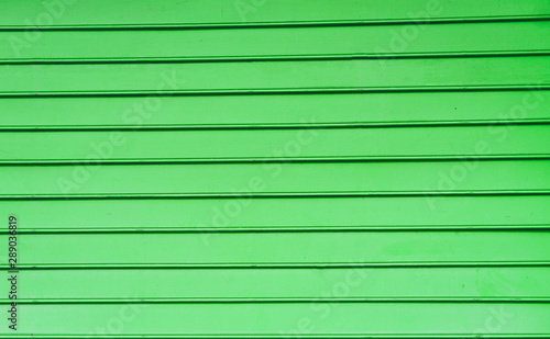 Pastel wood background texture with horizontal parallel boards color green