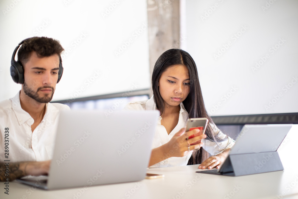 young couple European and asiatic working on computer young couple European and asiatic working on computer