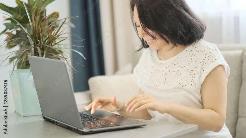 slow motion. Confident Businesswoman Working on a Laptop in Her Modern Office. Stylish Beautiful Woman Doing Important Job. In the Window Big City Business District View slow motion. Confident Businesswoman Working on a Laptop in Her Modern Office. Stylish Beautiful Woman Doing Important Job. In the Window Big City Business District View