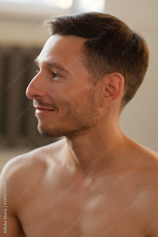 Obraz premium Closeup portrait of a smiling yoga trainer with naked torso and stubble on his face