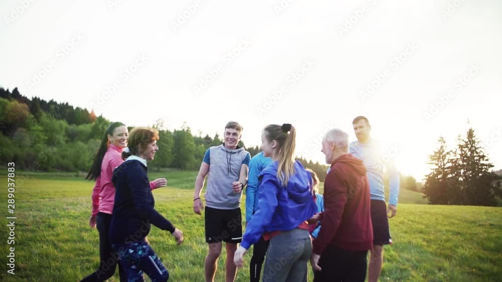 Large group of fit and active people jumping after doing exercise in nature. Large group of fit and active people jumping after doing exercise in nature.