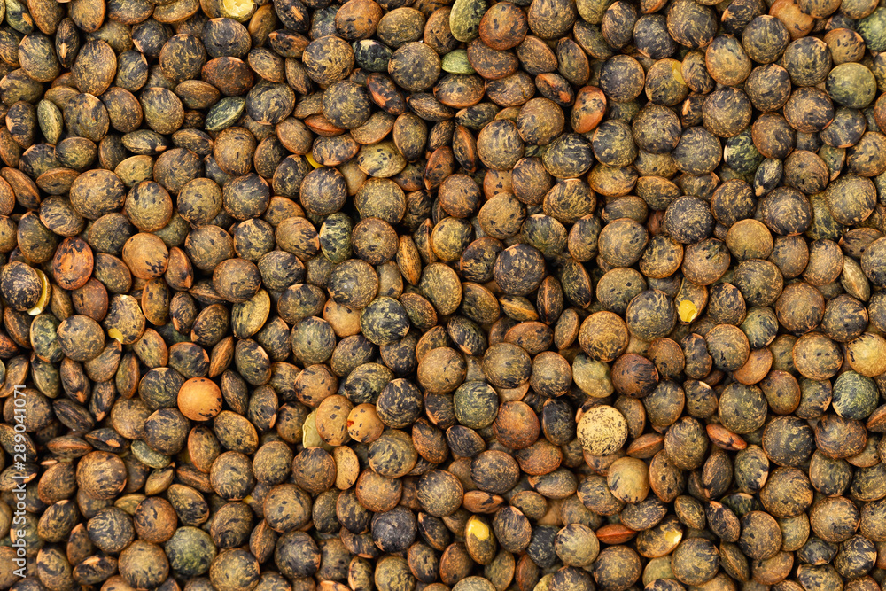 Flatlay closeup image of brown lentils as a natural healthy food background. Flatlay closeup image of brown lentils as a natural healthy food background.
