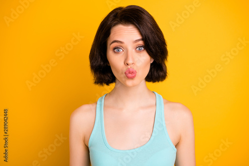 Photo of nice cute cheerful amazing girl kissing you through camera while isolated with yellow background