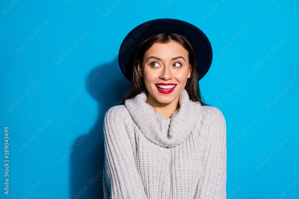 Pretty lady looking empty space cheerful laughing wear warm knitted pullover isolated blue background - obrazy, fototapety, plakaty 
