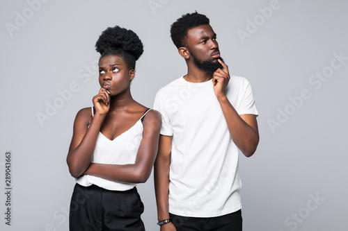 Beautiful African couple looking at the camera with unhappy offended expression  not speaking to each other. Body language