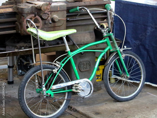 Milan, Italy - May 21, 2017: evocative imagine of old green vintage bicycle as a boy